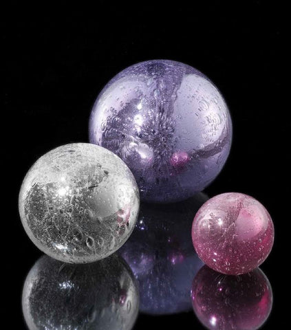Spheres in crystal, ruby and violet glass