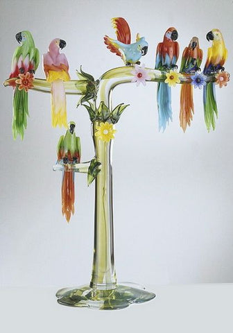 Seven colourful Murano glass parrots on a high branch