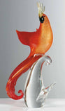Red and gold parrot on a crystal base