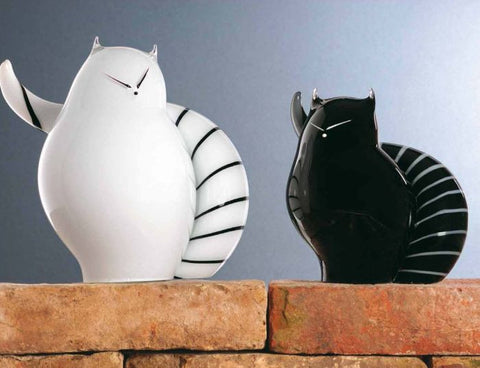 Modern white and black cats with striped tails