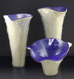 Ivory vases with irridescent purple interiors
