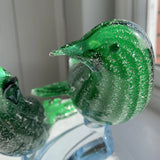 Green murano glass birds on a low branch